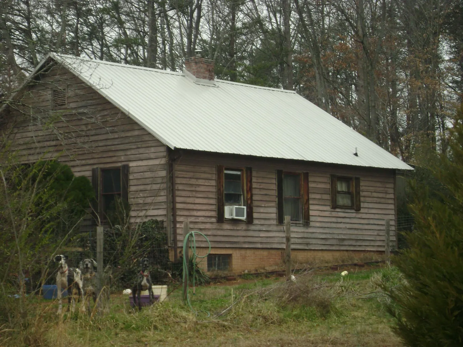 White metal roof on an old wood sided farmhouse, from a Metal Roof Installation job in Hacksneck